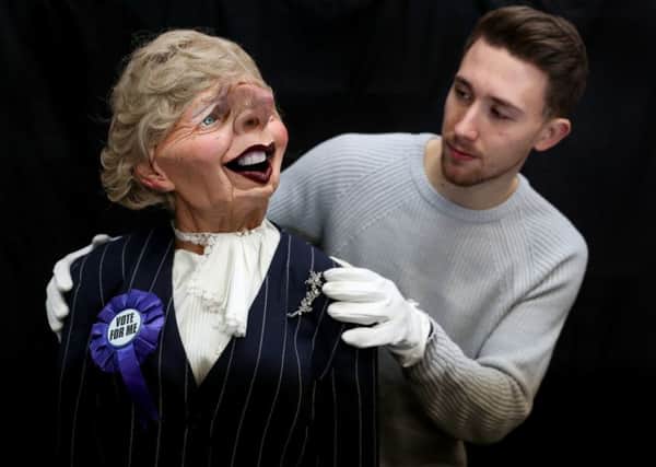 A Prop Store employee adjusts a Spitting Image puppet of Margaret Thatcher during a preview of the forthcoming Spitting Image auction at the Prop Store head office near Rickmansworth. PIC: PA