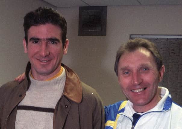 Famous French footballer, Eric Cantona, is pictured signing for Leeds United in February 1992. He is seen with then manager, Howard Wilkinson.

pic by Mike Cowling Yorkshire Evening Post
