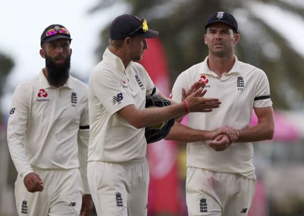 It's all gone wrong: England's captain Joe Root, centre, James Anderson, right, and Moeen Ali leave the field after losing by 10 wickets against the West Indies.