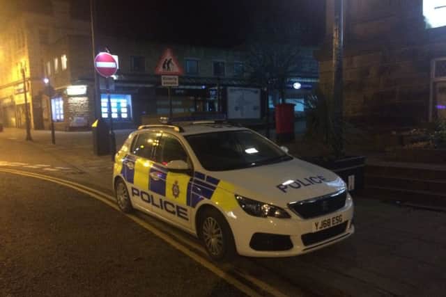 A police car parked at the bottom of Windsor Court last night.