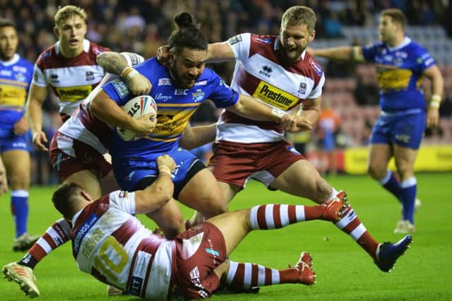 Konileti Hurrell is tackled by the Wigan defence.