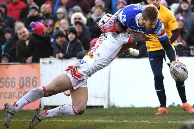 Wakefield's Tom Johnstone beats Saints Theo Fages to claim his spectacular first try. PIC: Jonathan Gawthorpe