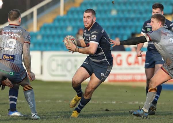 Cameron Smith of Featherstone Rovers takes on the Batley Bulldogs' defence.