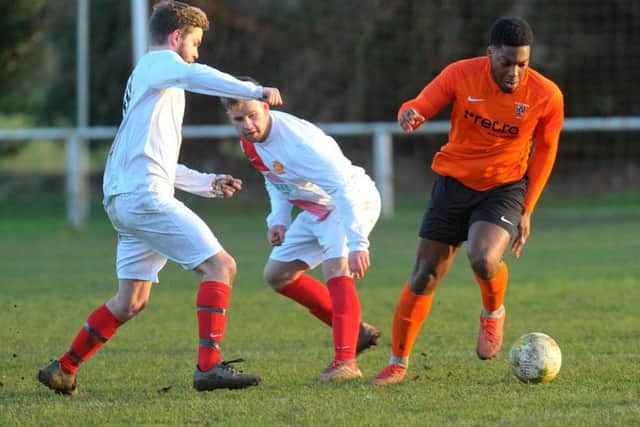 Kyle Bartley, of Otley Town, wins the ball. PIC: Steve Riding