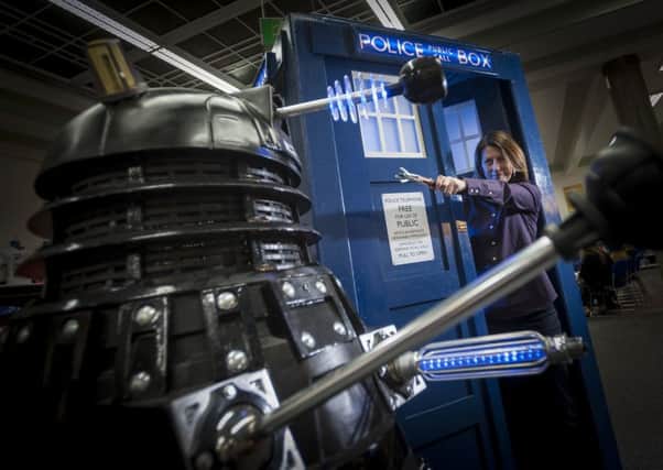 DOCTOR IN THE HOUSE: Huddersfield Literature Festival director Michelle Hodgson gets close up and personal with a Dalek at the preview. PIC: Jonathan Jacob