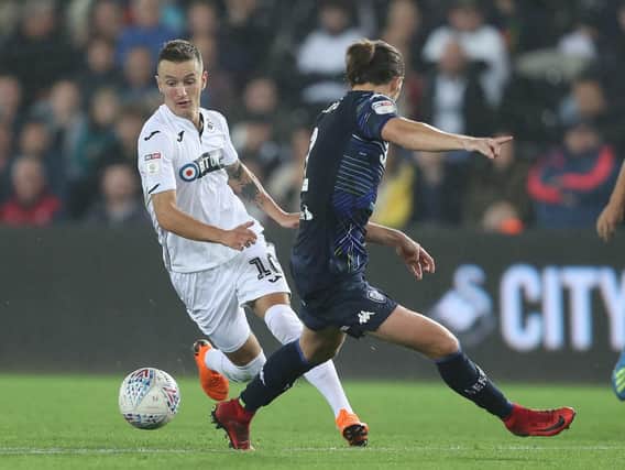 GOING WELL: Swansea City and Bersant Celina, left, have lost just one of their last nine and the Swans have the best passing completion rate in the division.