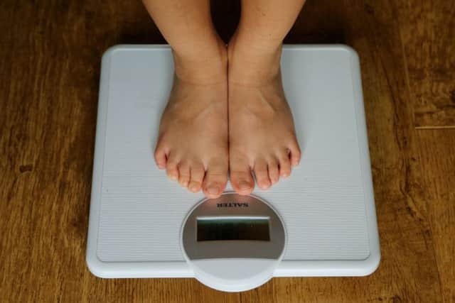 Embargoed to 2330 Tuesday October 30File photo dated 15/07/14 of a child being weighed on scales. Taking antibiotics in infancy has been linked to a higher risk of obesity, a study suggests. PRESS ASSOCIATION Photo. Issue date: Tuesday October 30, 2018. Researchers said the drugs may alter gut bacteria, making a child more susceptible to weight gain. See PA story HEALTH Obesity. Photo credit should read: Gareth Fuller/PA Wire