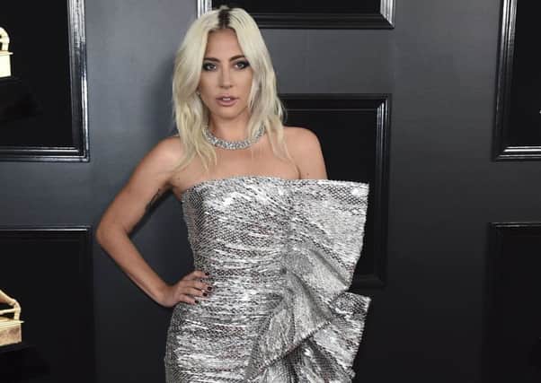 METALLICS (and exaggerated ruffles). Lady Gaga - nominated in the Oscars Best Actress category - stepped out for the Grammys wearing a metallic strapless side ruffle gown by Celine by Hedi Slimane, teamed with Jimmy Choo shoes and Tiffany & Co jewellery. On her it works, not least because she keeps accessories, hair and make-up unusually low-key. But then, this lady has never been afraid of a big dress. Picture: Jordan Strauss/Invision/AP)