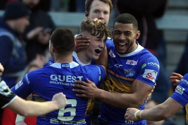 Harry Newman, centre, is congratulated by Kallum Watkins after scoring against Castleford.