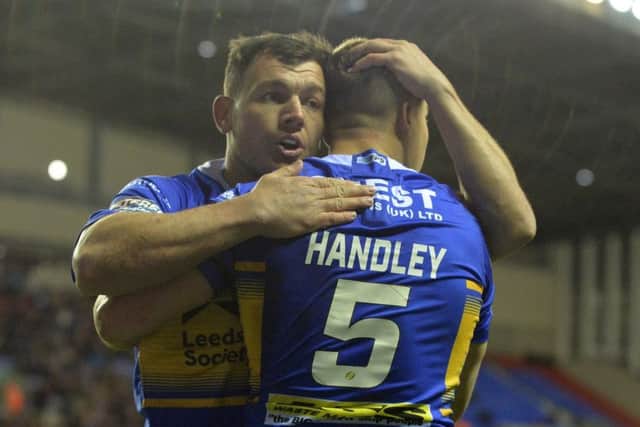 Ash Handley celebrates his opening try at Wigan with Brett Ferres.