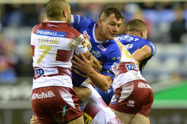 Brett Ferres is held by Wigan's Thomas Leuluai.