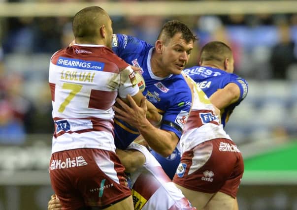Brett Ferres is held by Wigan's Thomas Leuluai.
