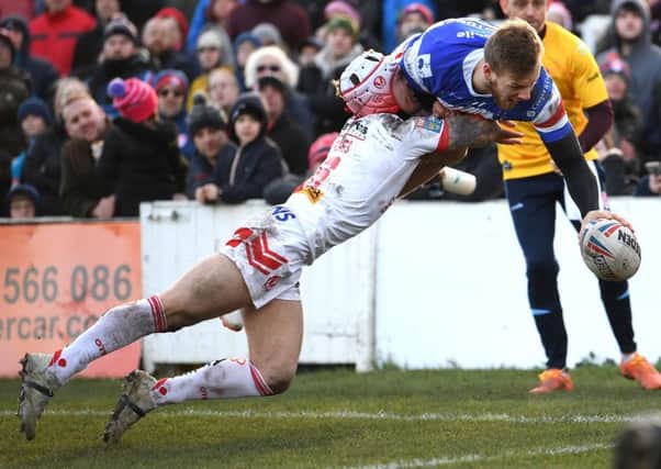 Wakefield's Tom Johnstone touches down to score against St Helens.