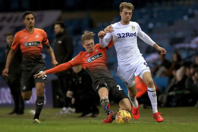 Swansea City's George Byers tackles Leeds United's Patrick Bamford.
