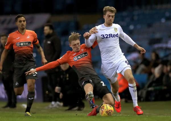 Swansea City's George Byers (left) tackles Leeds United's Patrick Bamford during the Sky Bet Championship match at Elland Road, Leeds. Photo by Mike Egerton/PA Wire.
