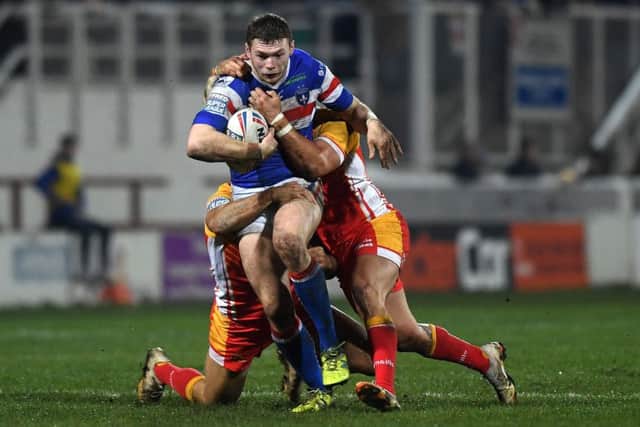 Wakefield's James Batchelor is halted by Catalans defence. (Picture: Jonathan Gawthorpe)