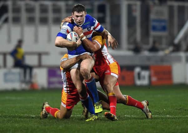 Wakefield's James Batchelor is halted by Catalans defence. (Picture: Jonathan Gawthorpe)