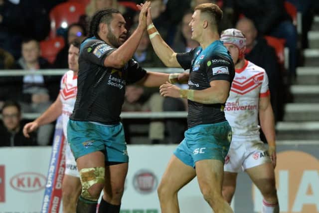 Ash Handley celebrates with Konrad Hurrell after scoring Leeds Rhinos' third try at St Helens.