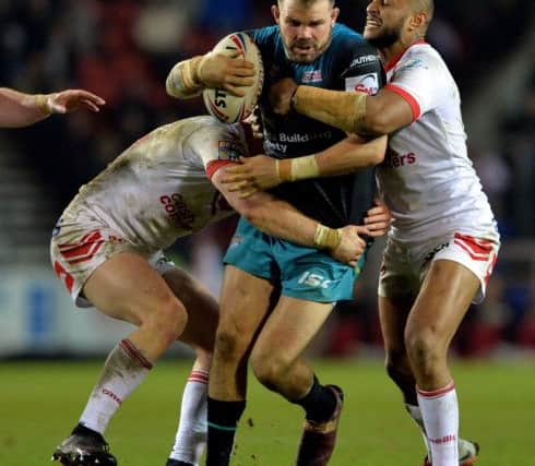 Adam Cuthbertson is held by Luke Thompson and Dom Peyroux.