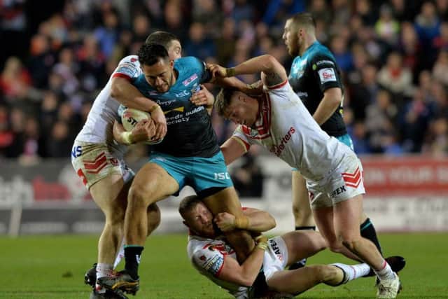 Nathaniel Peteru is held by Kyle Amor and Morgan Knowles. Picture: Bruce Rollinson.