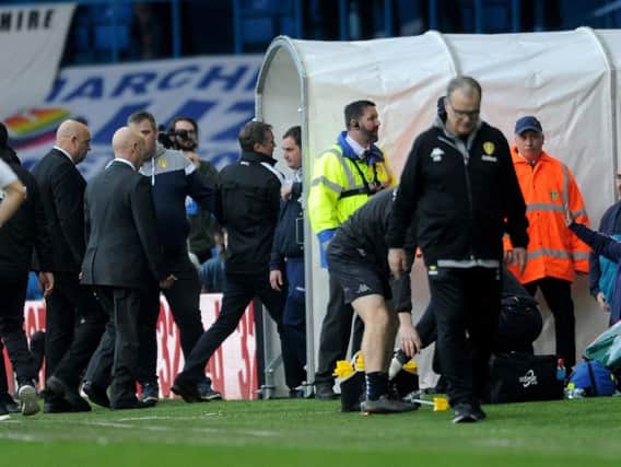 Bolton manager Phil Parkinson is led down the tunnel as Leeds United's Marcelo Bielsa returns to his technical area.