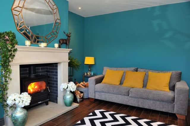 The new sitting room is painted in Farrow and Ball's Vardo. The flooring is wood-effect porcelain and the fireplace was one of Lyndsey's favourite buys.