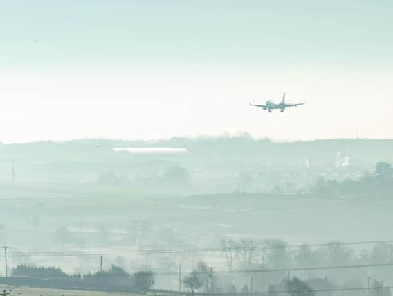 A jet comes in to land in heavy fog at Leeds Bradford Airport