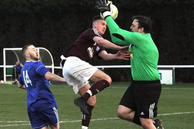 Headingley goalkeeper, Alex Buteux, saves under pressure from Nathan Kemp of Carlton. PIC: Steve Riding