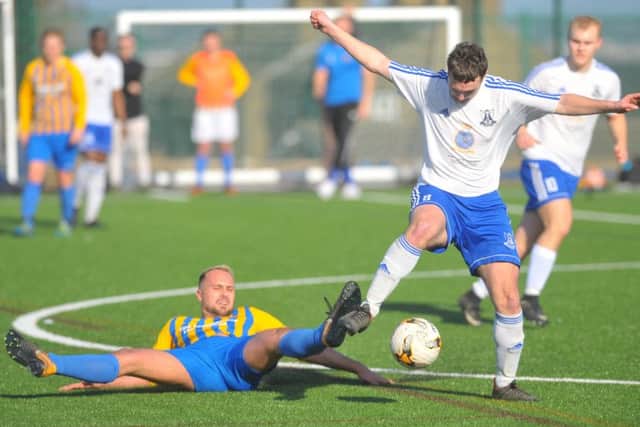 Greg Rowell, of Horsforth, tries to tackle Mark Dixon of Leeds City FC during Saints' 2-1 Old Boys' Shield quarter-final win. PIC: Steve Riding