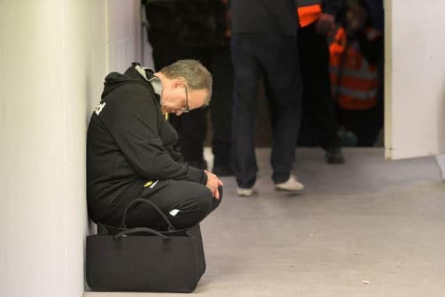 Leeds United head coach Marcelo Bielsa takes a moment to reflect outside the dressing room at Loftus Road.