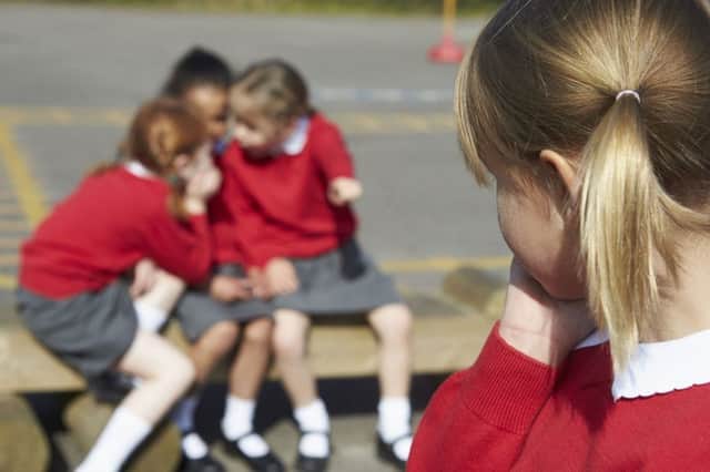 A Generic Photo of elementary school girls whispering in playground about another pupil. See PA Feature FAMILY Lonely. Picture credit should read: PA Photo/thinkstockphotos. WARNING: This picture must only be used to accompany PA Feature FAMILY Lonely.