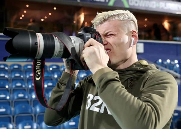 Ezgjan Alioski tries his hand with a camera ahead of the game with QPR at Loftus Road. PIC: PA
