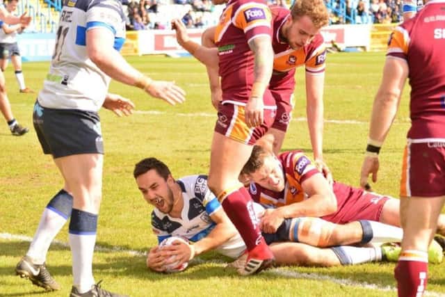 Holmes scores for Featherstone against Batley last year.