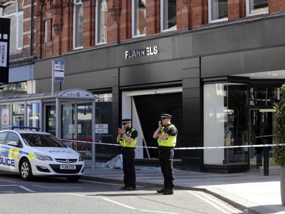 Police outside Flannels after the second of the three ram raids on the shop, June 2018