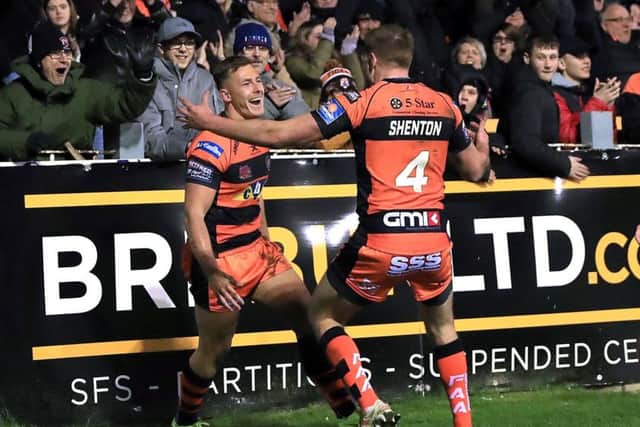 Castleford Tigers' Greg Eden (left) celebrates scoring a try against Hull KR on Friday night. Picture: Simon Cooper/PA