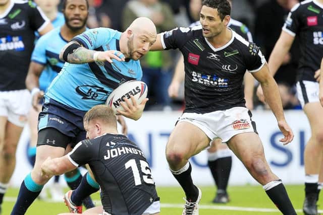 Widnes' Jordan Johnson tackles Featherstone's John Davies.