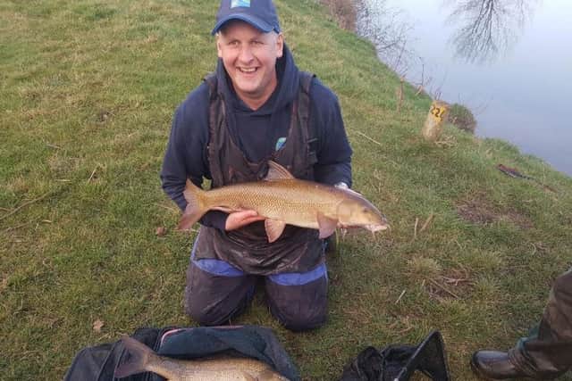 Stuart Tate cradles a barbel weighing in at 9-12 he caught on the bungalows section of the River Swale.