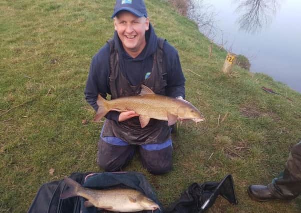 Stuart Tate cradles a barbel weighing in at 9-12 he caught on the bungalows section of the River Swale.