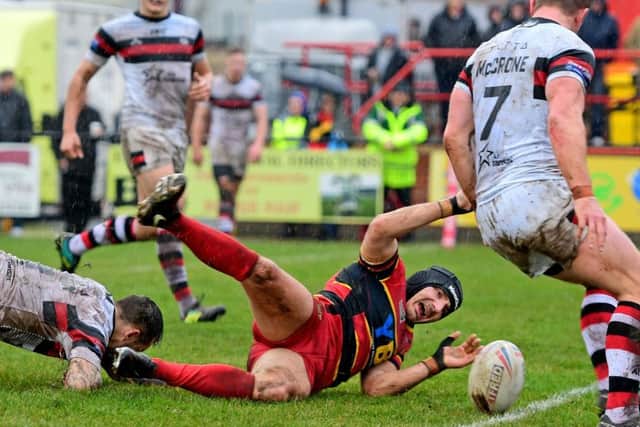 Dewsbury's Michael Knowles touches down for a try against Toronto.