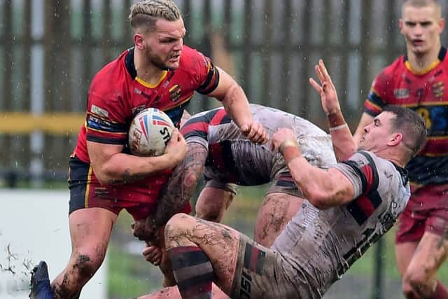 Dewsbury's Kyle Trout takes on Toronto's Darcy Lussick.
