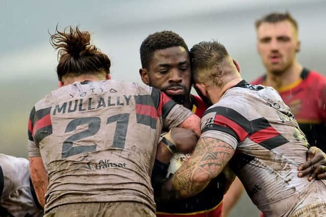 Dewsbury's Dan Igbinedion is tackled by the Toronto defence.