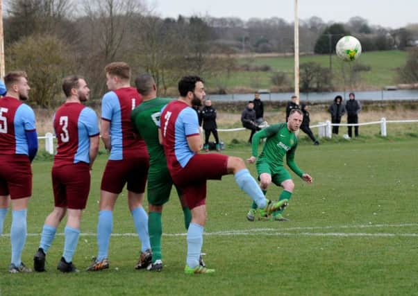 Dan Daly, of Beeston St Anthony's, scores the winner over Rawdon Old Boys. PIC: Steve Riding