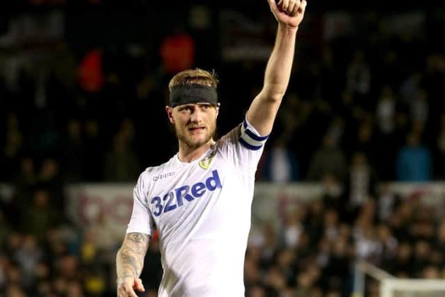 A bandaged Liam Cooper salutes the crowd at Elland Road after Leeds United's crushing win over West Brom.