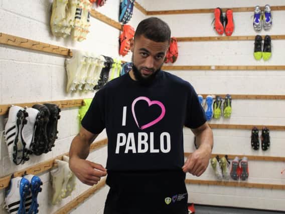 Kemar Roofe tries on the range's Pablo Hernandez T-shirt - complete with a tongue-in-cheek look of disdain.