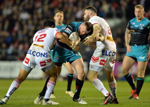 Brad Singleton takes on Joseph Paulo and Theo Fages of St Helens.