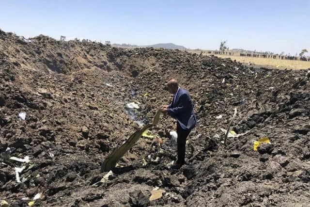 The CEO of Ethiopian Airlines, Tewolde Gebremariam, looks at the wreckage of the plane that crashed shortly after takeoff from Addis Ababa.