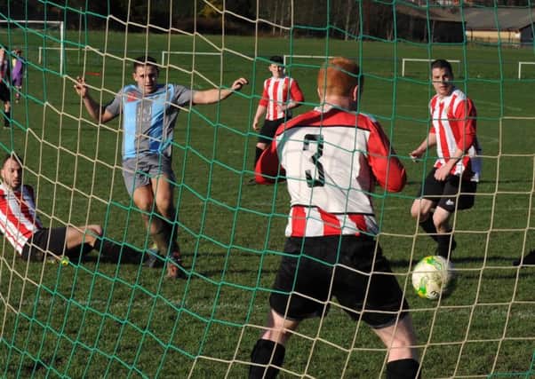 Swillington's promotion hopes were dealt a blow when they were held to a 3-3 draw
 by visitors Old Centralians. Jake Witcher scores the third goal for Swillington. PIC: Steve Riding