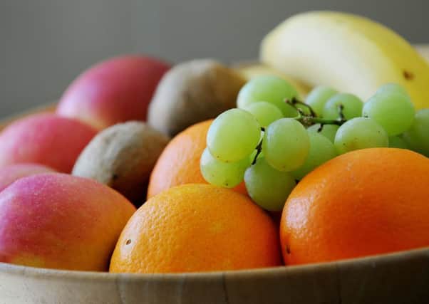 Grapes, Oranges, apples bananas and Kiwifruit in a fruit bowl.