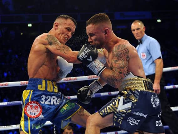 Josh Warrington lands a right hand on Carl Frampton during their dramatic clash in Manchester before Christmas.