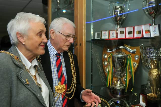 Couns Graham and Pat Latty looking at the trophies in the cabinet at The Hunslet Club in Leeds.